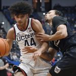 
              Connecticut's Andre Jackson is guarded by Butler's Jair Bolden, right, during the first half of an NCAA college basketball game Tuesday, Jan. 18, 2022, in Hartford, Conn. (AP Photo/Jessica Hill)
            