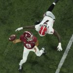 
              Georgia's Quay Walker forces an early thorw by Alabama's Bryce Young during the first half of the College Football Playoff championship football game Monday, Jan. 10, 2022, in Indianapolis. (AP Photo/Charlie Riedel)
            