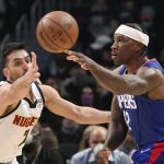
              Los Angeles Clippers guard Eric Bledsoe, right, passes the ball as Denver Nuggets guard Facundo Campazzo defends during the first half of an NBA basketball game Tuesday, Jan. 11, 2022, in Los Angeles. (AP Photo/Mark J. Terrill)
            