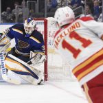 
              Calgary Flames center Mikael Backlund (11) scores a goal past St. Louis Blues goaltender Ville Husso (35) during the first period of an NHL hockey game Thursday, Jan. 27, 2022, in St. Louis. (AP Photo/Joe Puetz)
            