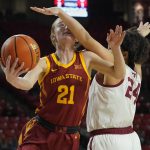 
              Iowa State guard Lexi Donarski (21) goes to the basket while defended by Oklahoma guard Skylar Vann (24) during the first half of an NCAA college basketball game Wednesday, Jan. 5, 2022, in Norman, Okla. (AP Photo/Sue Ogrocki)
            