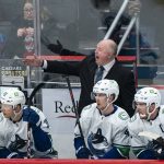 
              Vancouver Canucks head coach Bruce Boudreau, top, advises his team during the first period of an NHL hockey game against the Washington Capitals, Sunday, Jan. 16, 2022, in Washington. (AP Photo/Al Drago)
            