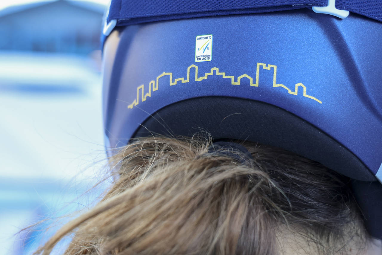 Italy's Sofia Goggia sports Bergamo's skyline on the back of her racing helmet, in the finish area ...