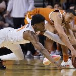 
              Oklahoma State guard Bryce Williams, left, and Texas forward Dylan Disu, right, reach for the ball in the second half of an NCAA college basketball game Saturday, Jan. 8, 2022, in Stillwater, Okla. (AP Photo/Sue Ogrocki)
            