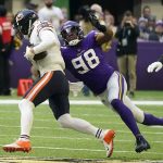 
              Chicago Bears quarterback Andy Dalton (14) is sacked by Minnesota Vikings defensive end D.J. Wonnum (98) during the first half of an NFL football game, Sunday, Jan. 9, 2022, in Minneapolis. (AP Photo/Jim Mone)
            
