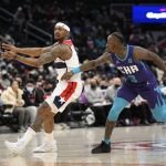 
              Washington Wizards guard Bradley Beal, left, passes the ball next to Charlotte Hornets guard Terry Rozier (3) during the first half of an NBA basketball game, Monday, Jan. 3, 2022, in Washington. (AP Photo/Nick Wass)
            