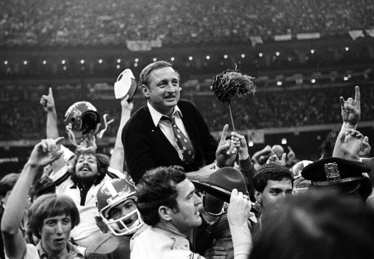 FILE - Georgia football coach Vince Dooley is carried off the field after Georgia defeated Notre Da...