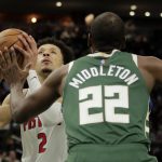 
              Detroit Pistons' Cade Cunningham, left, drives to the basket against Milwaukee Bucks' Khris Middleton (22) during the first half of an NBA basketball game Monday, Jan. 3, 2022, in Milwaukee. (AP Photo/Aaron Gash)
            