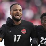 
              Canada's Cyle Larin, 17, celebrates his goal against the United States with teammate Richie Laryea, 22, during the first half of a World Cup soccer qualifier in Hamilton, Ontario, Sunday, Jan. 30, 2022. (Nathan Denette/The Canadian Press via AP)
            