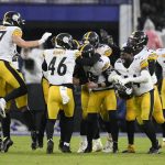 
              Pittsburgh Steelers players mob kicker Chris Boswell (9) after he kicked the game-winning field goal during overtime of an NFL football game against the Baltimore Ravens, Sunday, Jan. 9, 2022, in Baltimore. The Steelers won 16-13. (AP Photo/Nick Wass)
            