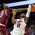 
              South Carolina guard James Reese V (0) knocks the ball away from Arkansas guard Chris Lykes (11) during the first half of an NCAA college basketball game Tuesday, Jan. 18, 2022, in Fayetteville, Ark. (AP Photo/Michael Woods)
            