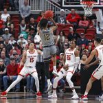 
              West Virginia's Taz Sherman (12) shoots the ball over Texas Tech's Adonis Arms (25) during the first half of an NCAA college basketball game on Saturday, Jan. 22, 2022, in Lubbock, Texas. (AP Photo/Brad Tollefson)
            