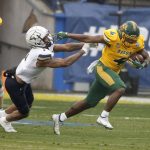 
              North Dakota State running back Kobe Johnson (4) breaks away from Montana State defensive back Eric Zambrano (1) for a long touchdown run during the first half of the FCS Championship NCAA college football game in Frisco, Texas, Saturday, Jan. 8, 2022. (AP Photo/Michael Ainsworth)
            