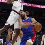 
              Cleveland Cavaliers center Evan Mobley (4) hits Detroit Pistons forward Trey Lyles while trying to defend against a shot during the first half of an NBA basketball game Sunday, Jan. 30, 2022, in Detroit. (AP Photo/Duane Burleson)
            