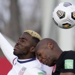 
              United States' Gyasi Zardes, left, and Canada's Kamal Miller, right, vie for the ball during the first half of World Cup qualifying soccer action in Hamilton, Ont.ario, Sunday, Jan. 30, 2022. (Frank Gunn/The Canadian Press via AP)
            