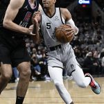 
              San Antonio Spurs' Dejounte Murray (5) drives against Los Angeles Clippers' Ivica Zubac during the first half of an NBA basketball game, Saturday, Jan. 15, 2022, in San Antonio. (AP Photo/Darren Abate)
            