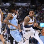 
              Denver Nuggets guard Monte Morris, right, drives past Memphis Grizzlies guard Ja Morant during the first half of an NBA basketball game Friday, Jan. 21, 2022, in Denver. (AP Photo/David Zalubowski)
            