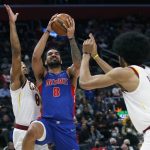 
              Detroit Pistons forward Trey Lyles (8) goes to the basket against Cleveland Cavaliers forward Lamar Stevens, left, and center Jarrett Allen, front right, during the first half of an NBA basketball game Sunday, Jan. 30, 2022, in Detroit. (AP Photo/Duane Burleson)
            