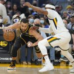 
              Golden State Warriors guard Stephen Curry, left, drives to the basket against Utah Jazz guard Mike Conley during the first half of an NBA basketball game in San Francisco, Sunday, Jan. 23, 2022. (AP Photo/Jeff Chiu)
            