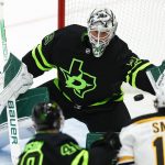 
              Dallas Stars goaltender Jake Oettinger (29) stops a shot on goal as forward Jacob Peterson (40) and Boston Bruins forward Craig Smith (12) look on and during the third period of an NHL hockey game, Sunday, Jan. 30, 2022, in Dallas. (AP Photo/Brandon Wade)
            