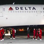 
              The Alabama team disembarks from a plane Friday, Jan. 7, 2022, at Indianapolis International Airport in Indianapolis. Alabama is scheduled to play Georgia on Monday in the College Football Playoff championship game. (Michelle Pemberton/The Indianapolis Star via AP)
            