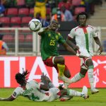 
              Cameroon's Nouhou Tolo, centre is challenged by Burkina Faso's Issoufou Dayo, during the African Cup of Nations 2022 group A soccer match between Cameroon and Burkina Faso at the Olembe stadium in Yaounde, Cameroon, Sunday, Jan. 9, 2022. (AP Photo/Themba Hadebe)
            