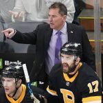 
              Boston Bruins coach Bruce Cassidy calls to officials during the first period of the team's NHL hockey game against the New Jersey Devils, Tuesday, Jan. 4, 2022, in Boston. (AP Photo/Charles Krupa)
            