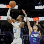 
              Orlando Magic guard Terrence Ross (31) makes a jumper as Charlotte Hornets guard LaMelo Ball (2) attempts the block from behind during the first half of an NBA basketball game on Friday, Jan. 14, 2022, in Charlotte, N.C. (AP Photo/Rusty Jones)
            