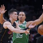 
              Miami Heat guard Tyler Herro, left, passes the ball while pressured by Boston Celtics forward Grant Williams (12) during the first half of an NBA basketball game, Monday, Jan. 31, 2022, in Boston. (AP Photo/Charles Krupa)
            