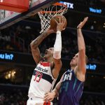 
              Washington Wizards forward Kyle Kuzma (33) goes to the basket against Charlotte Hornets center Mason Plumlee, right, during the first half of an NBA basketball game, Monday, Jan. 3, 2022, in Washington. (AP Photo/Nick Wass)
            