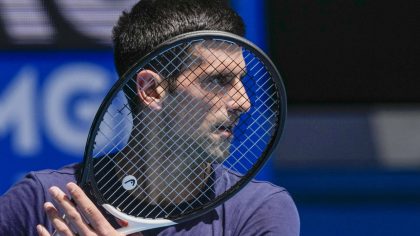 FILE - Defending champion Serbia's Novak Djokovic practices ahead of the Australian Open tennis cha...
