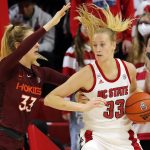 
              Virginia Tech's Elizabeth Kitle , left, battles with North Carolina State's Elissa Cunane, right, during the first half of an NCAA college basketball game, Sunday, Jan. 23, 2022, in Raleigh, N.C. (AP Photo/Karl B. DeBlaker)
            