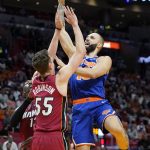 
              New York Knicks guard Evan Fournier, right, goes to the basket as Miami Heat guard Duncan Robinson (55) defends during the first half of an NBA basketball game, Wednesday, Jan. 26, 2022, in Miami. (AP Photo/Lynne Sladky)
            