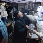 
              A medical worker wearing a protective suit swabs a resident for a coronavirus test in Huaxian County in central China's Henan Province, Friday, Jan. 14, 2022. China further tightened its anti-pandemic measures in Beijing and across the country on Friday as scattered outbreaks continued ahead of the opening of the Winter Olympics in a little over two weeks. (Chinatopix via AP)
            
