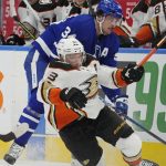 
              Toronto Maple Leafs' Auston Matthews (34) checks Anaheim Ducks' Jakob Silfverberg (33) during the first period of an NHL hockey game in Toronto on Wednesday, Jan 26, 2022. (Frank Gunn/The Canadian Press via AP)
            