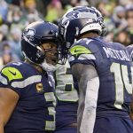 
              Seattle Seahawks quarterback Russell Wilson, left, reacts with wide receiver DK Metcalf (14) after he passed Metcalf for a touchdown against the Detroit Lions during the second half of an NFL football game, Sunday, Jan. 2, 2022, in Seattle. (AP Photo/Elaine Thompson)
            