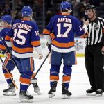 
              New York Islanders left wing Matt Martin (17) shakes hands with referee Dean Morton (36) after an NHL hockey game against the Los Angeles Kings,  Thursday, Jan. 27, 2022, in Elmont, N.Y. (AP Photo/Adam Hunger)
            
