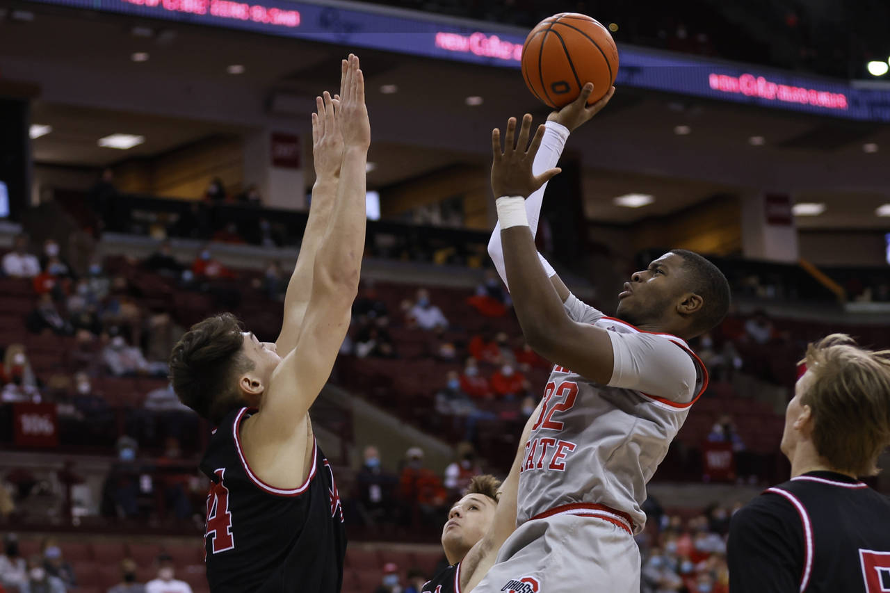 Ohio State's E.J. Liddell, right, shoots as IUPUI's Jonah Carrasco defends during the second half o...