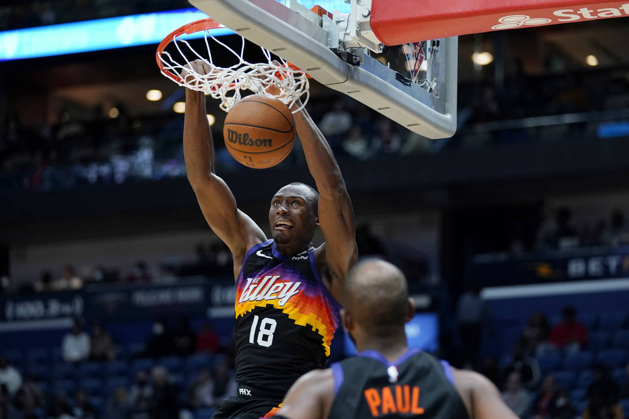 Phoenix Suns center Bimack Biyombo (18) clam dunks in the second half of an NBA basketball game aga...