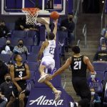 
              Washington guard Terrell Brown Jr., center, makes a shot between Colorado guard Keeshawn Barthelemy (3) and forward Evan Battey (21) during the second half of an NCAA college basketball game, Thursday, Jan. 27, 2022, in Seattle. Washington won 60-58. (AP Photo/Ted S. Warren)
            