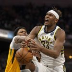 
              Indiana Pacers center Myles Turner (33) is fouled by Utah Jazz forward Rudy Gay (8) en route to the basket during the first half of an NBA basketball game in Indianapolis, Saturday, Jan. 8, 2022. (AP Photo/Doug McSchooler)
            