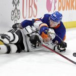 
              Los Angeles Kings center Blake Lizotte and New York Islanders defenseman Scott Mayfield (24) battle for the puck as they slide across the ice in the third period of an NHL hockey game Thursday, Jan. 27, 2022, in Elmont, N.Y. (AP Photo/Adam Hunger)
            
