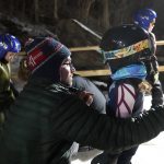 
              Jake Lindquist, left, gives his 4-year-old daughter Julia encouragement as she practices Tuesday, Jan. 18, 2022, at the Norge Ski Club in Fox River Grove, Ill. It’s not far fetched to suggest one or more of the young jumpers may land in the Olympics someday. (AP Photo/Charles Rex Arbogast)
            