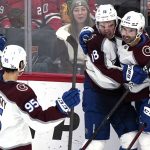 
              Colorado Avalanche center Alex Newhook, center, celebrates with left wing Andre Burakovsky, left, and center Nazem Kadri after scoring a goal during the third period of an NHL hockey game against the Chicago Blackhawks in Chicago, Friday, Jan. 28, 2022. (AP Photo/Nam Y. Huh)
            