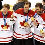 
              FILE - Team Canada players Eric Staal, from left, Chris Pronger, Joe Thornton and Michael Richards display their gold medals after winning the ice hockey gold medal final in overtime against Team USA at the 2010 Winter Olympic Games in Vancouver, Sunday, Feb. 28, 2010. Four years after walking away with a bronze medal after the NHL did not participate, Canada's team in Beijing has remnants of the ones that won gold in 2010 and 2014 and a roster that looks capable of doing it again. (AP Photo/Paul Chiasson, CP)
            