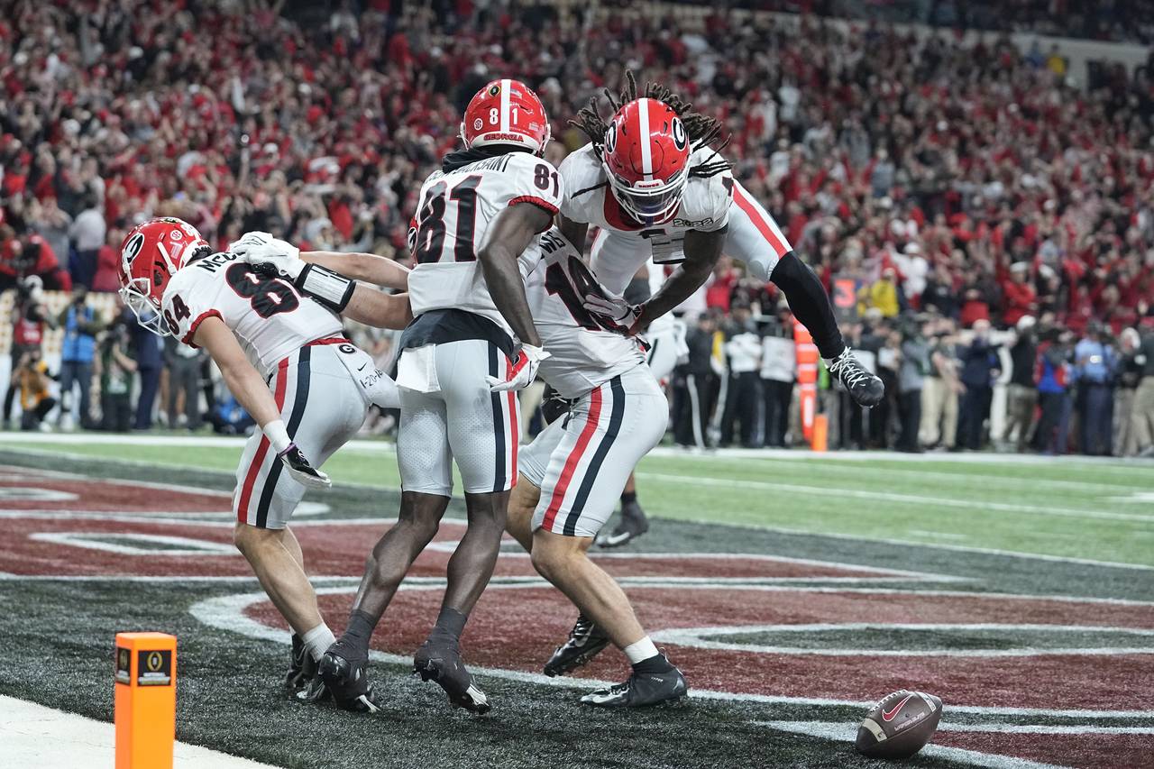 Georgia's Brock Bowers is congratulated after scoring a touchdown during the second half of the Col...