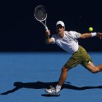 
              FILE - Serbia's Novak Djokovic returns to Andy Roddick, of the United States, in a Men's singles match at the Australian Open Tennis Championship in Melbourne, Australia, Jan. 27, 2009. (AP Photo/Mark Baker, File)
            