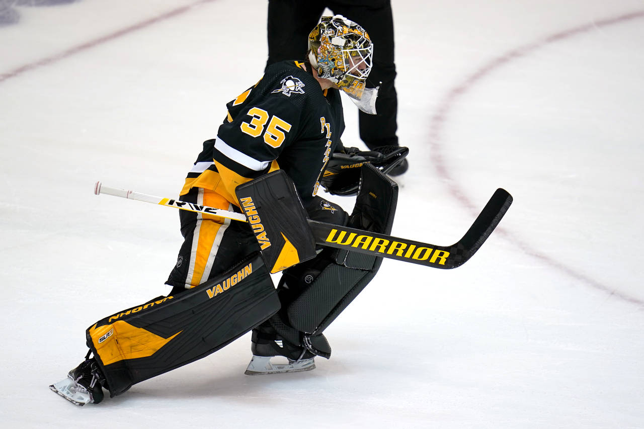 Pittsburgh Penguins goaltender Tristan Jarry begins to celebrate after blocking a shot by Winnipeg ...