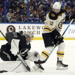 
              Tampa Bay Lightning goaltender Andrei Vasilevskiy (88) makes a save on a deflection by Boston Bruins center Craig Smith (12) during the first period of an NHL hockey game Saturday, Jan. 8, 2022, in Tampa, Fla. (AP Photo/Chris O'Meara)
            