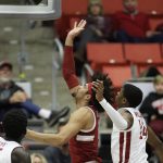 
              Stanford forward Jaiden Delaire, center, shoots in front of Washington State guard Noah Williams during the first half of an NCAA college basketball game, Thursday, Jan. 13, 2022, in Pullman, Wash. (AP Photo/Young Kwak)
            